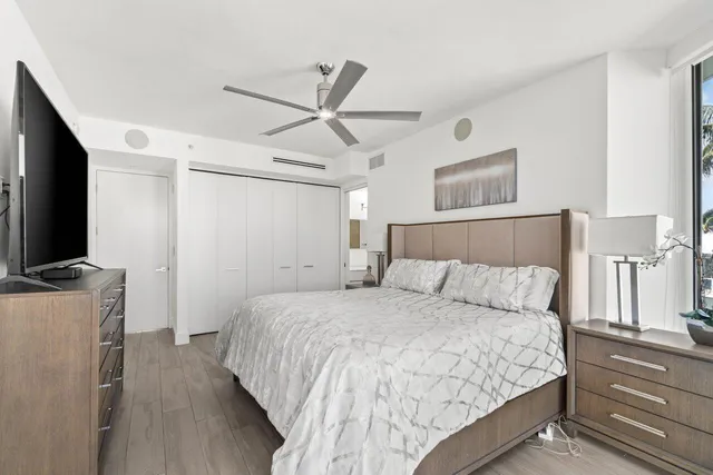 a bedroom with a bed and a flat screen tv