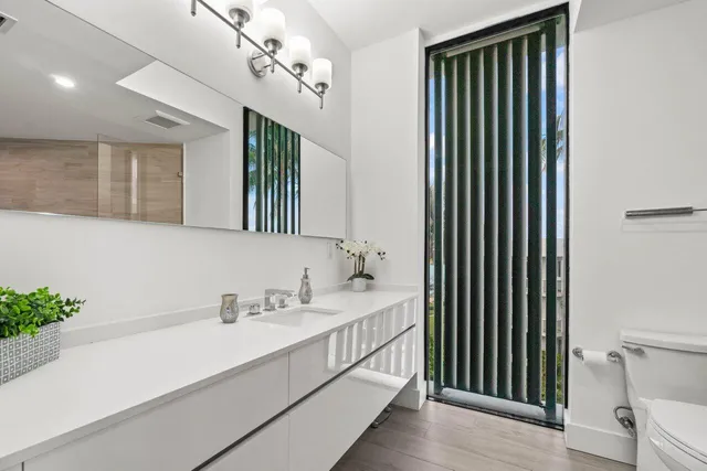 a bathroom with a sink a mirror and a shower
