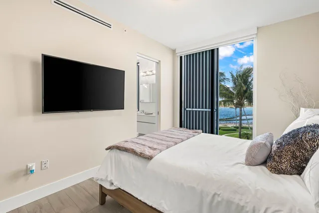 a bedroom with a bed and a flat screen tv