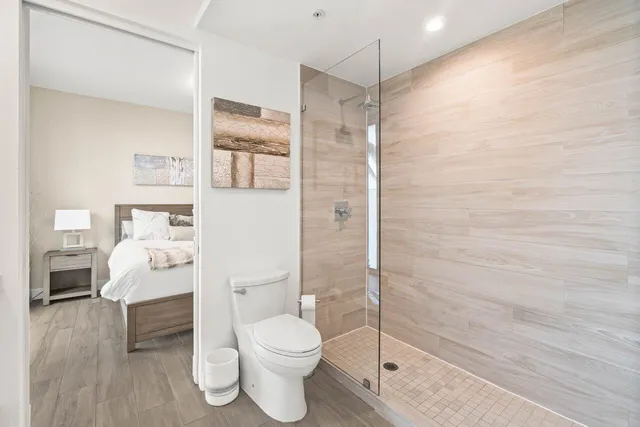 a bathroom with a toilet a sink and shower
