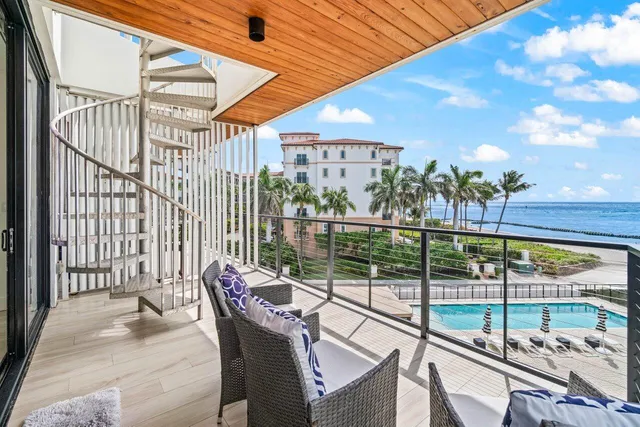 a view of a balcony with furniture