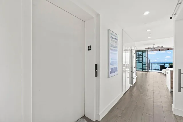 a view of a hallway with a view of a bathroom with a shower