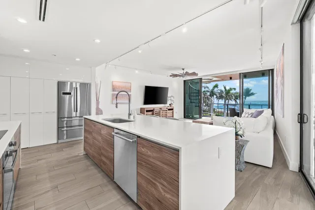a large white kitchen with a large window