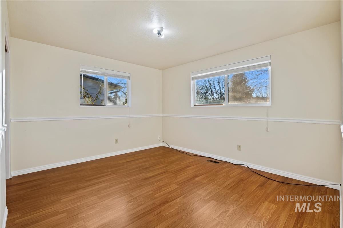 3850 Rugby Drive Boise, ID 83704 - Photo 29 of 44 Empty room featuring wood finished floors and baseboards