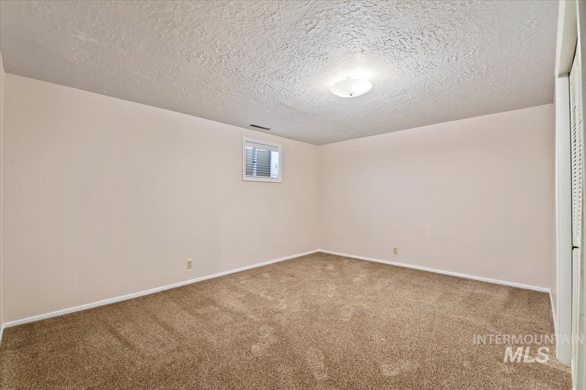3850 Rugby Drive Boise, ID 83704 - Photo 36 of 44 Unfurnished room with a textured ceiling and light colored carpet