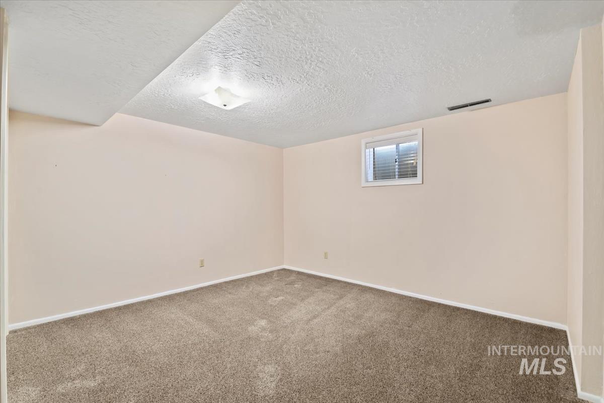 3850 Rugby Drive Boise, ID 83704 - Photo 39 of 44 Below grade area with carpet floors and a textured ceiling