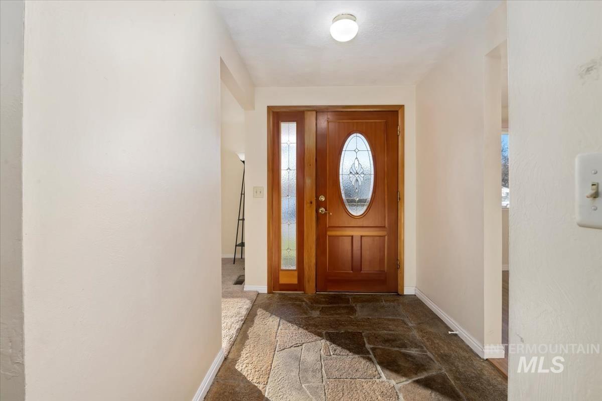 3850 Rugby Drive Boise, ID 83704 - Photo 7 of 44 Entrance foyer featuring stone tile floors and baseboards