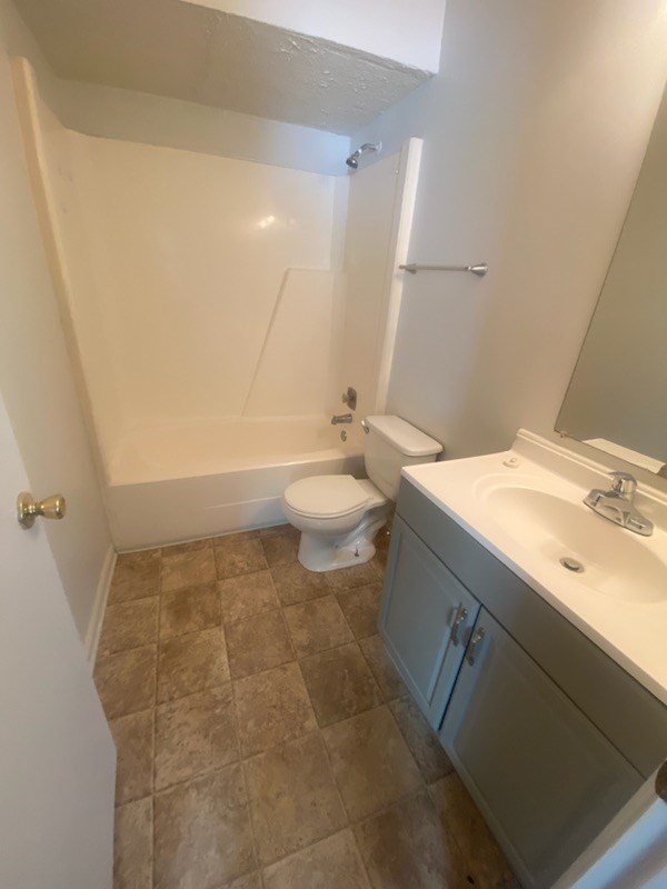 6908 Bullet Boulevard Columbus, GA 31907 - Photo 8 of 8 a bathroom with a sink a toilet and a mirror