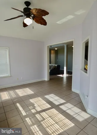an empty room with a chandelier fan