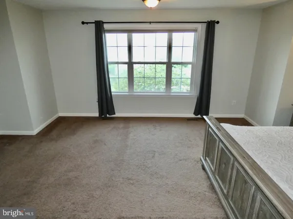 a living room with furniture and a mirror
