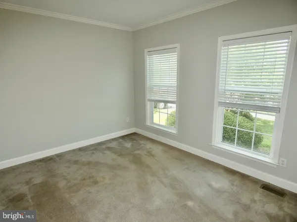 a dining room with furniture a chandelier and a rug