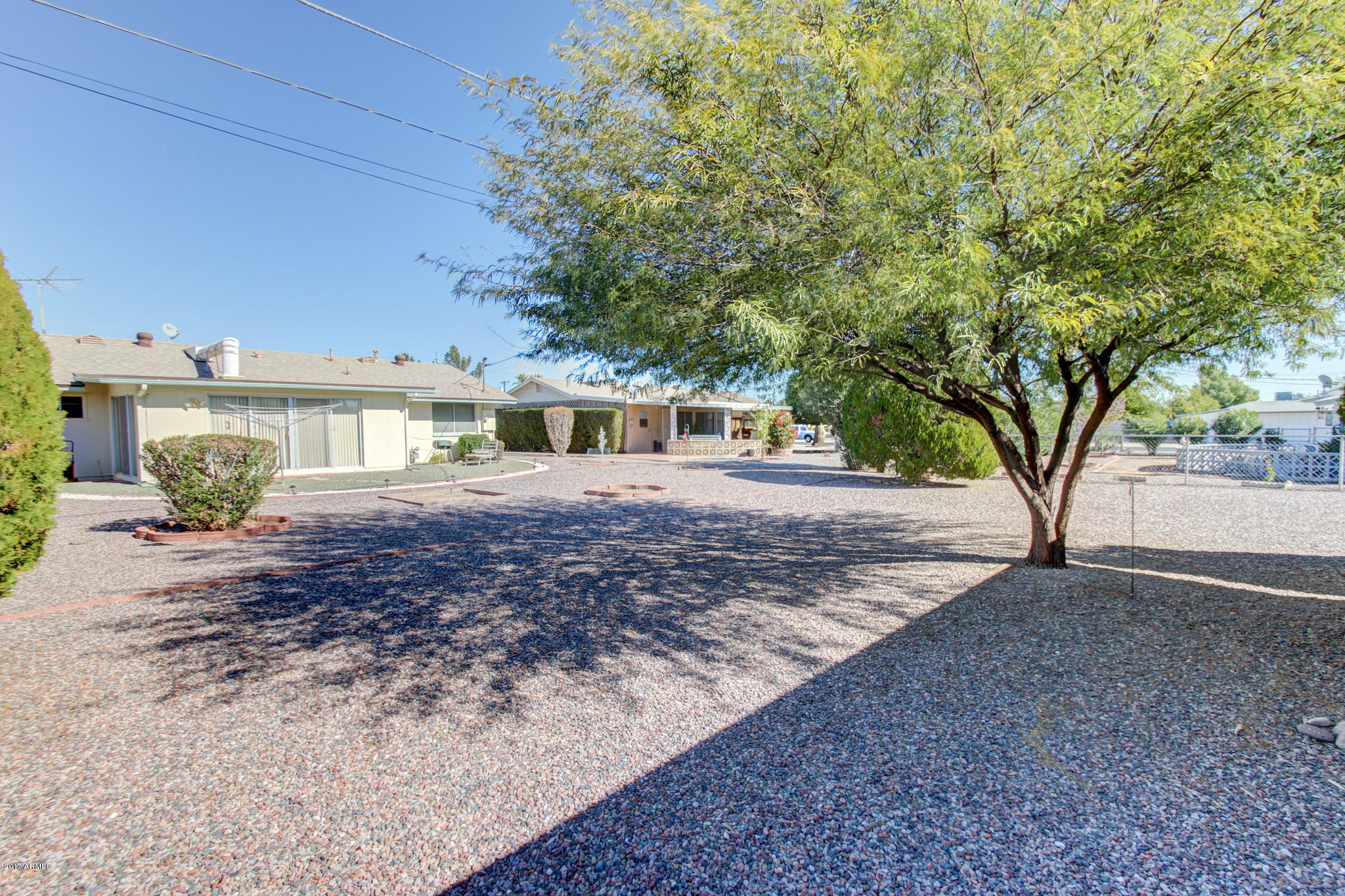 10008 West Riviera Drive Sun City, AZ 85351 - Photo 24 of 26 front view of a house with a trees