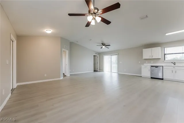 a view of a kitchen with a sink and a chandelier fan
