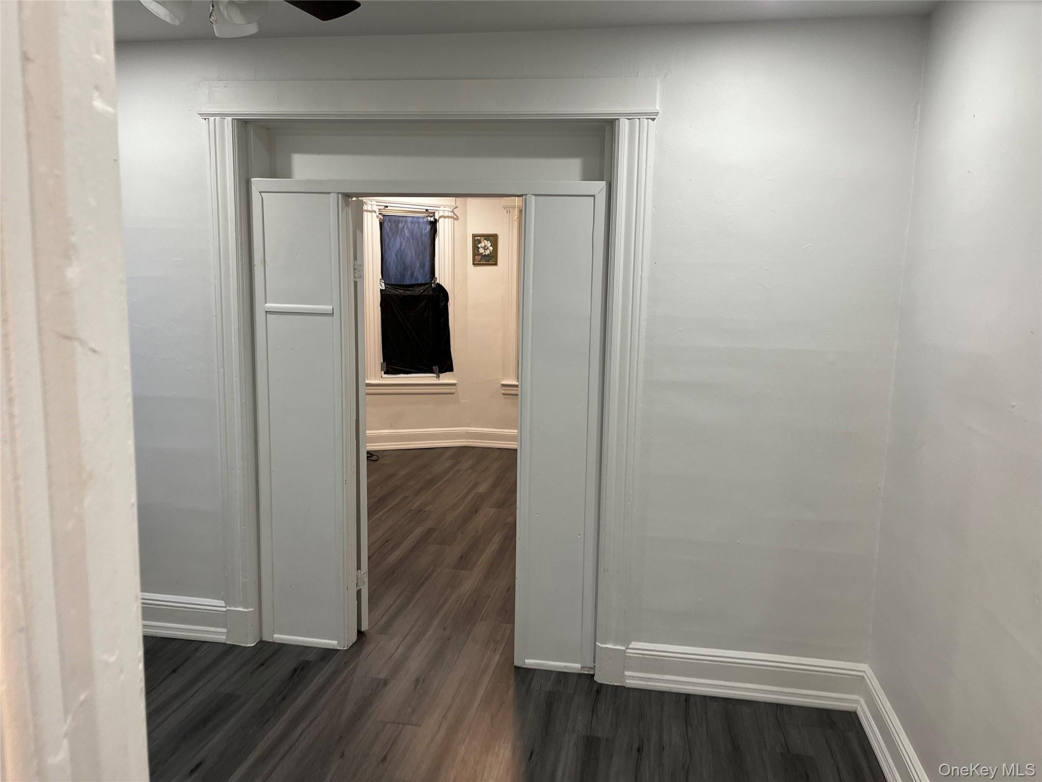 95-29 112th Street, Unit 2 Queens, NY 11419 - Photo 5 of 10 Hall with dark wood-style flooring and baseboards