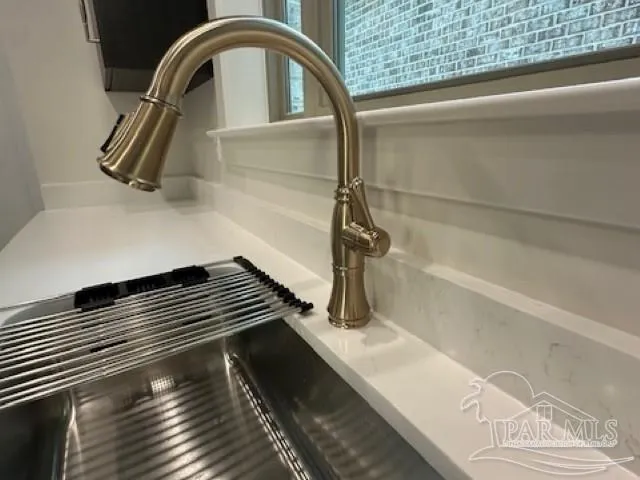 a view of an empty room and wooden floor with windows