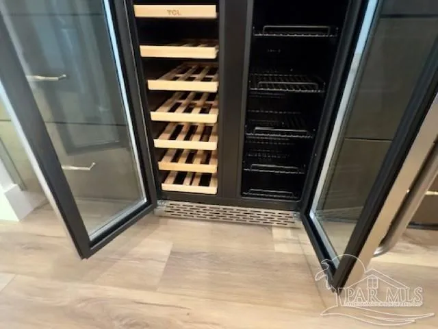 a view of room with kitchen island stainless steel appliances a stove a sink and a chandelier