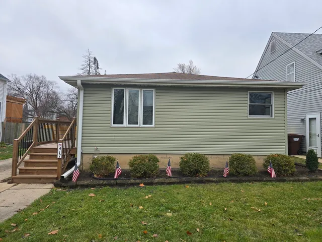 a front view of a house with a garden