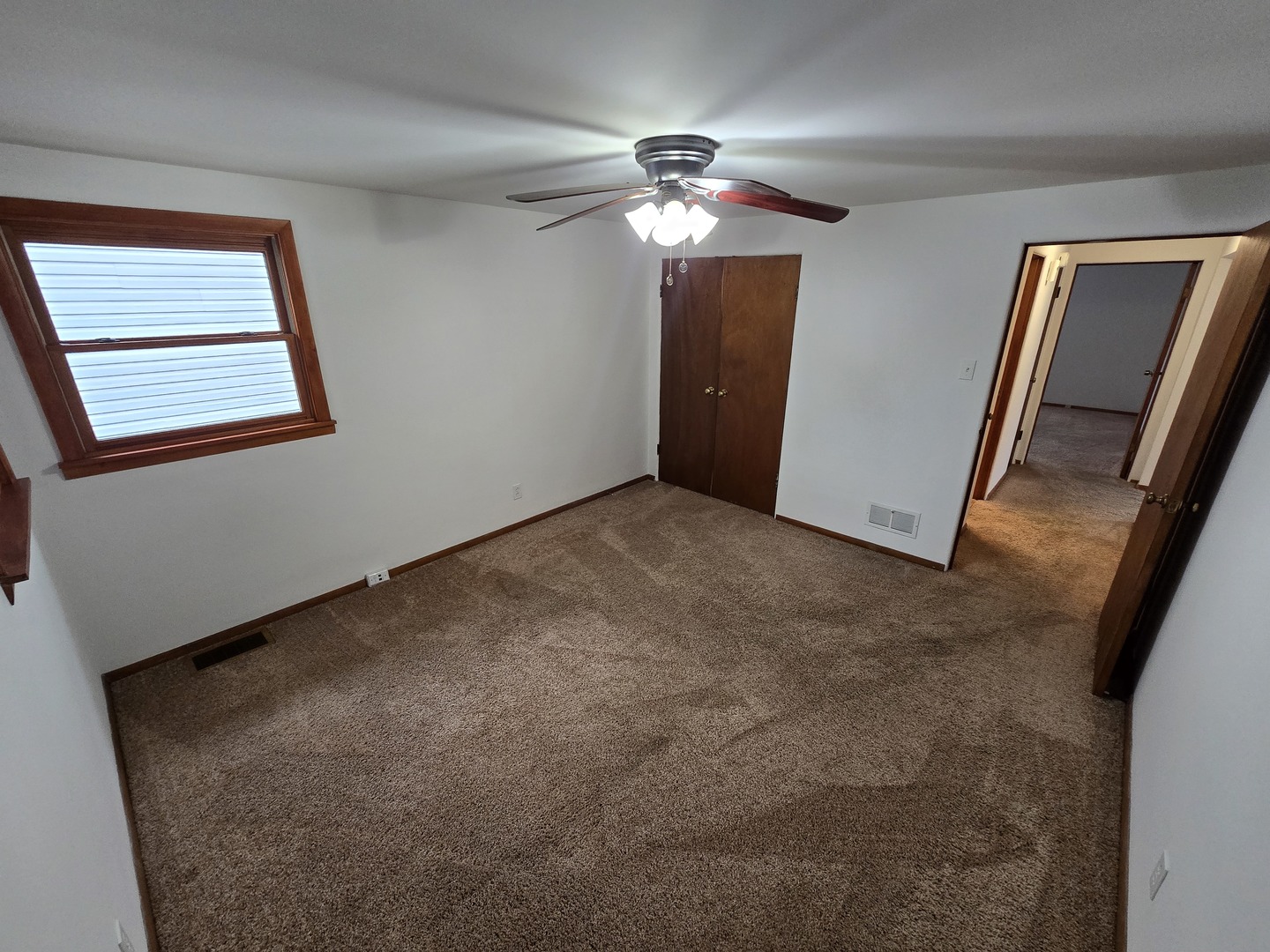 417 Stewart Avenue Woodstock, IL 60098 - Photo 13 of 22 a view of an empty room with a chandelier fan