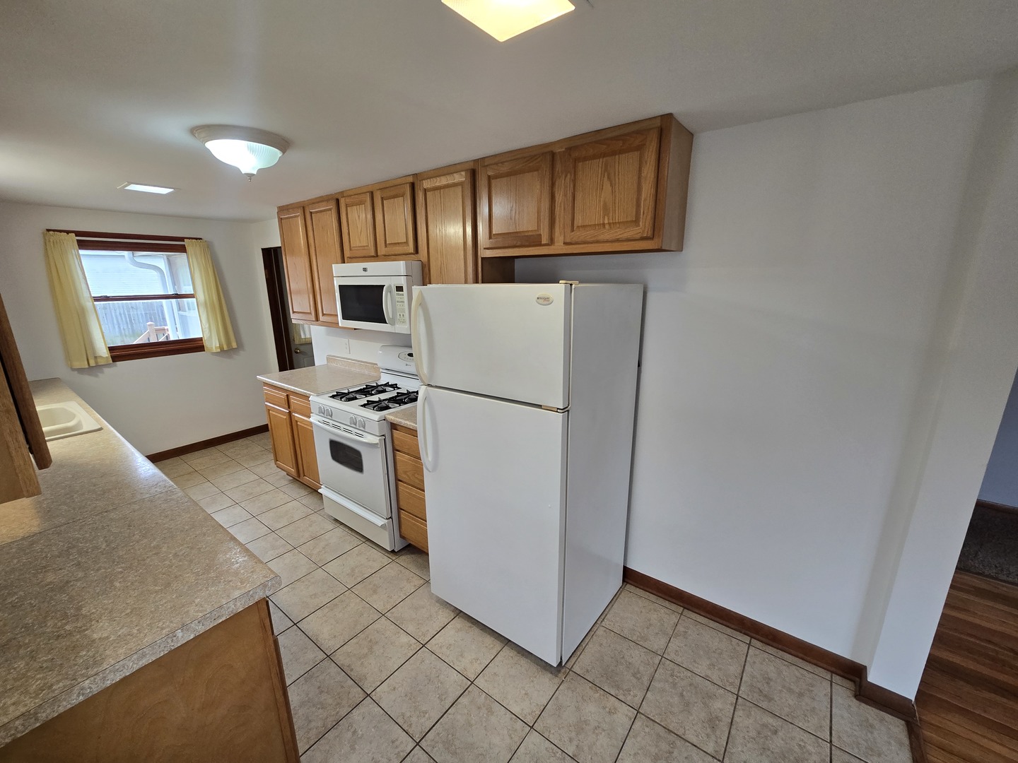 417 Stewart Avenue Woodstock, IL 60098 - Photo 8 of 22 a kitchen with stainless steel appliances granite countertop a refrigerator a stove a sink a microwave and cabinets