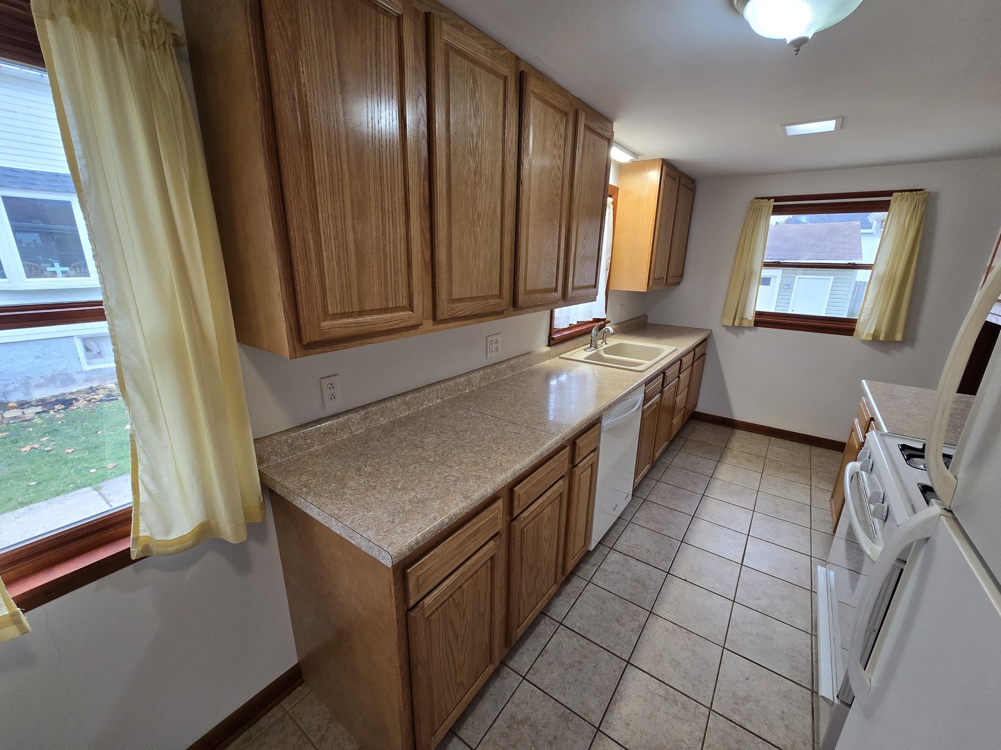 417 Stewart Avenue Woodstock, IL 60098 - Photo 9 of 22 a kitchen with a sink stove and cabinets