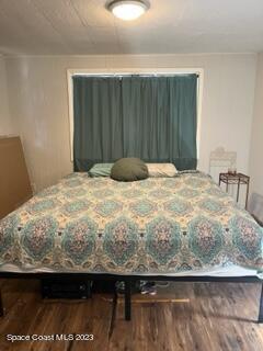 1450 Loring Street Cocoa, FL 32922 - Photo 11 of 16 a bedroom with a bed and a chair