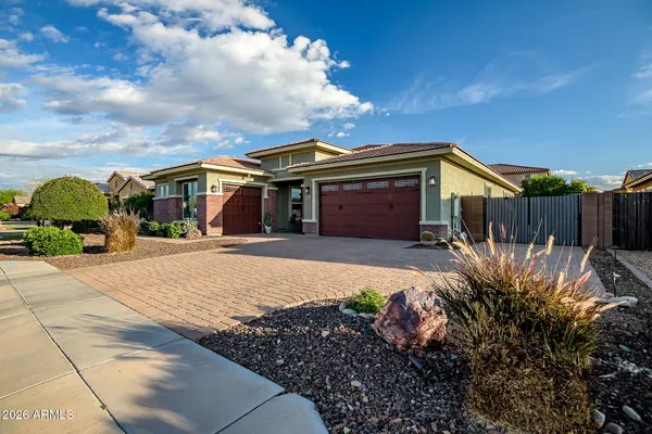 a front view of a house with a garden