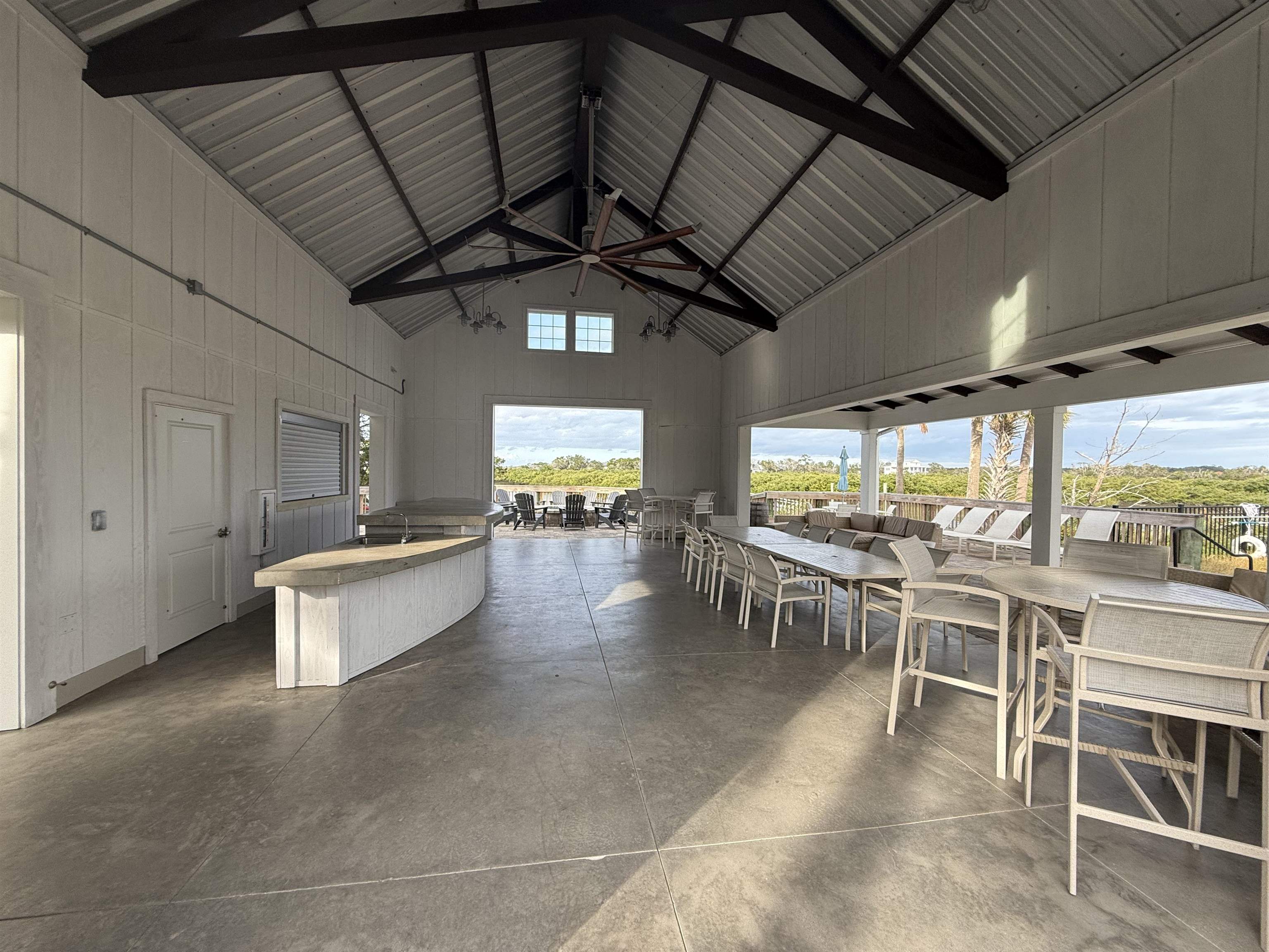 209 Leeward Island Drive St. Augustine, FL 32080 - Photo 15 of 22 a view of a patio with table and chairs with wooden floor