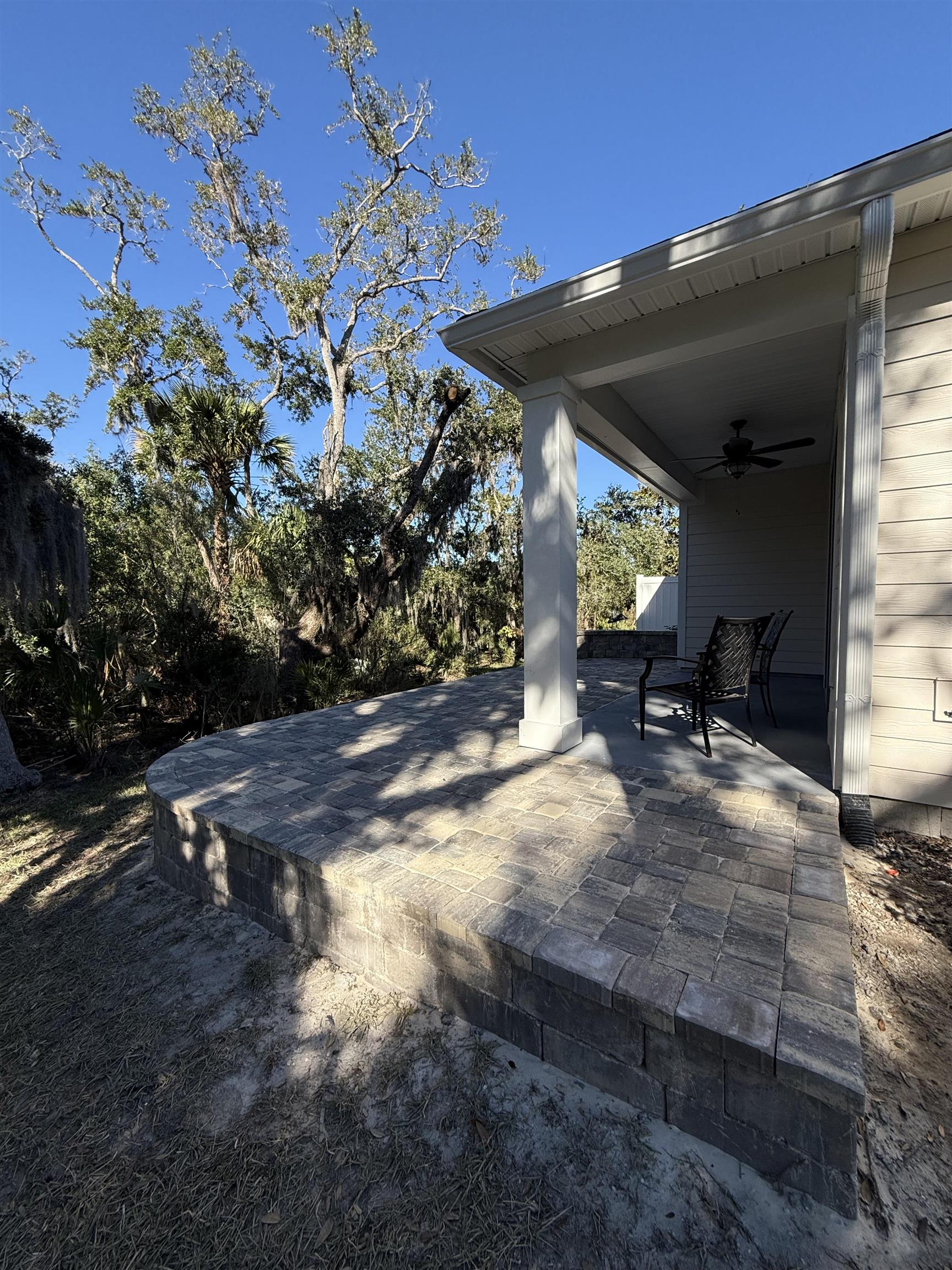 209 Leeward Island Drive St. Augustine, FL 32080 - Photo 22 of 22 a view of backyard with a table and chairs under an umbrella