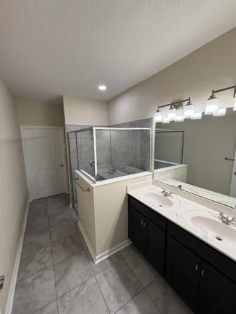 a bathroom with a sink vanity and mirror