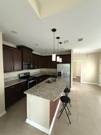 a kitchen with stainless steel appliances granite countertop a stove and a sink