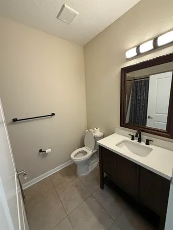 a bathroom with a sink a toilet and mirror