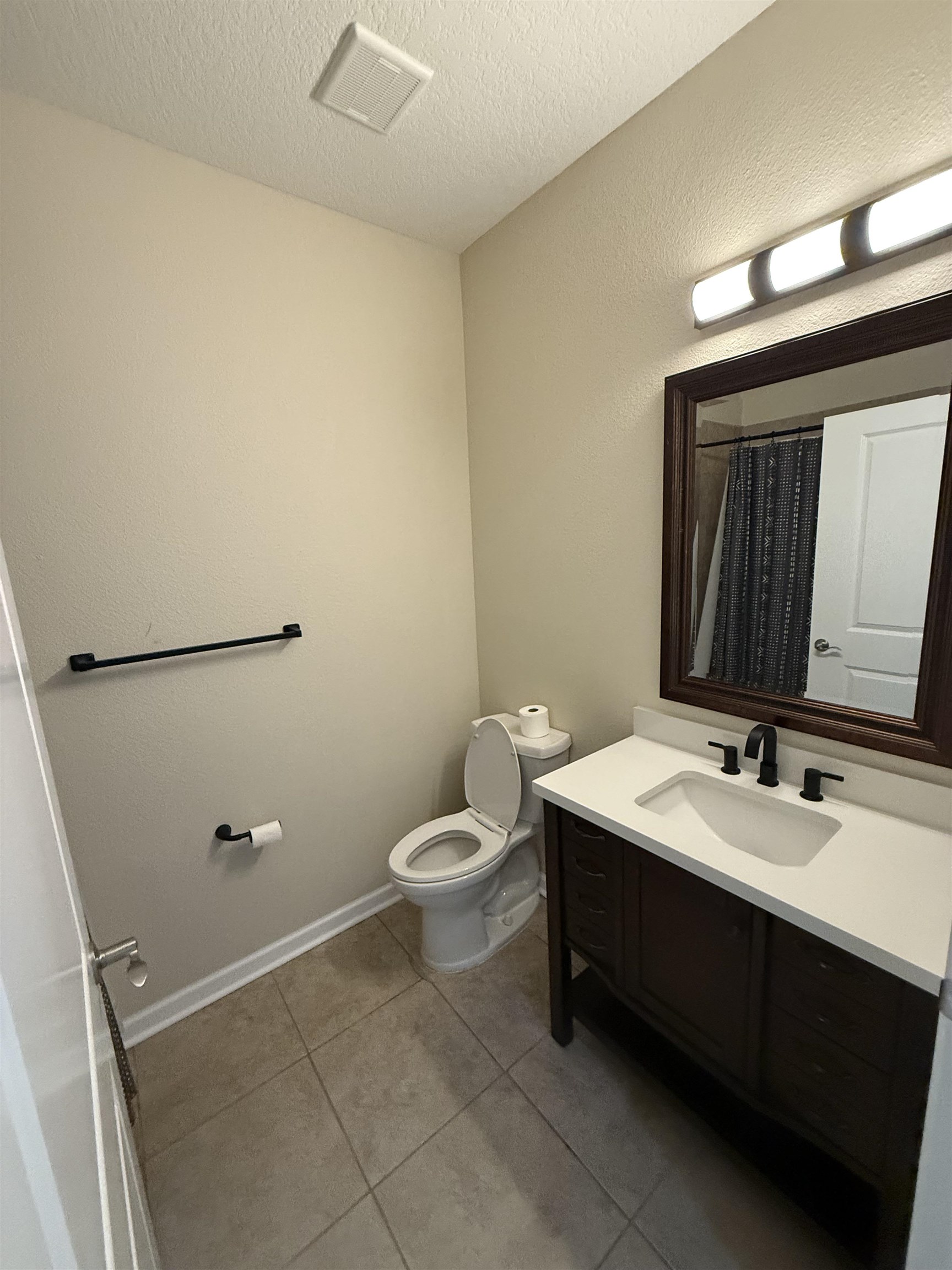 209 Leeward Island Drive St. Augustine, FL 32080 - Photo 10 of 22 a bathroom with a sink a toilet and mirror