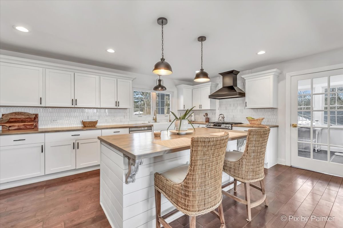 708 South Rose Farm Road Woodstock, IL 60098 - Photo 17 of 79 a kitchen with stainless steel appliances granite countertop a sink a stove a refrigerator and island with wooden floor