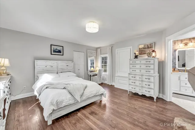 a large bedroom with a bed and glass door