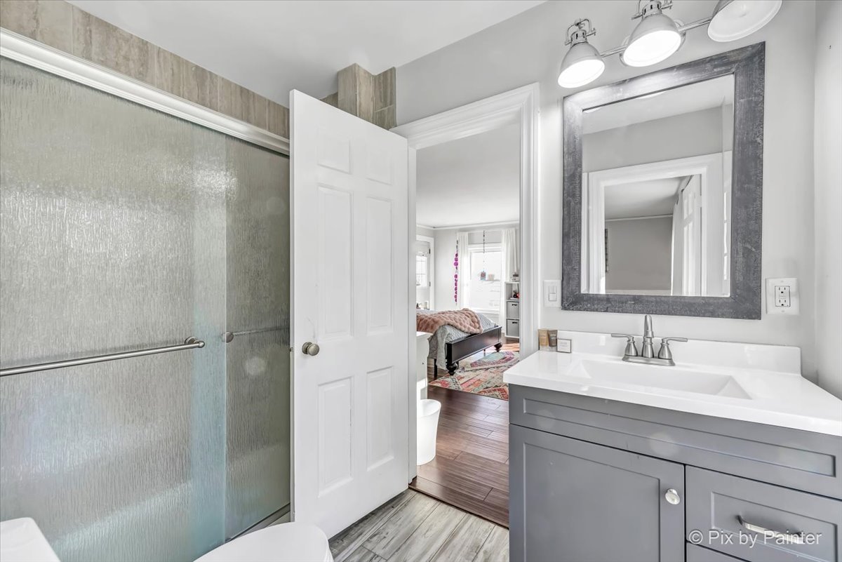 708 South Rose Farm Road Woodstock, IL 60098 - Photo 34 of 79 a en suite bathroom with a sink a mirror and a shower