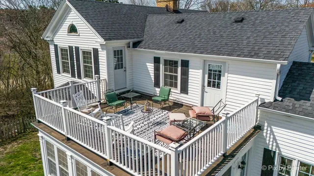 a backyard of a house with yard fire pit and outdoor seating