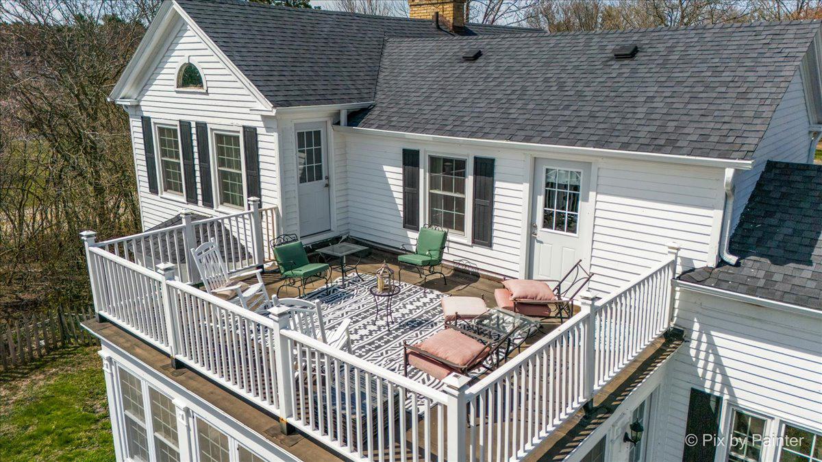 708 South Rose Farm Road Woodstock, IL 60098 - Photo 8 of 79 a view of a house with wooden deck and furniture