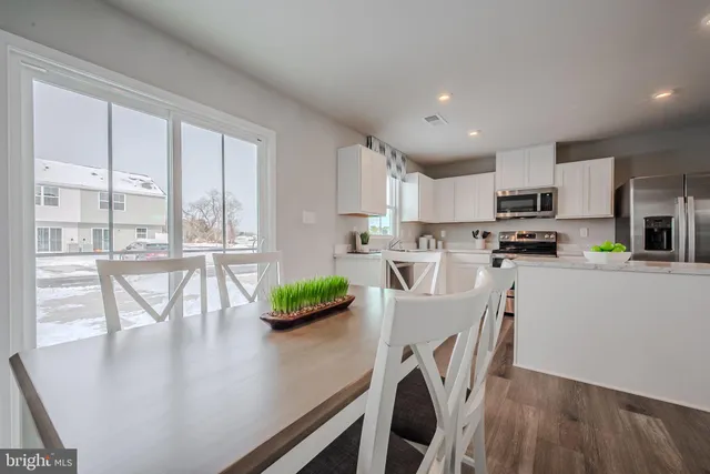 a kitchen with dining table and chairs