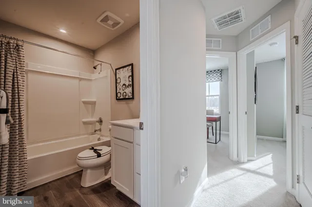 a bathroom with a toilet sink and shower