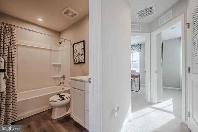 a bathroom with a toilet sink and shower
