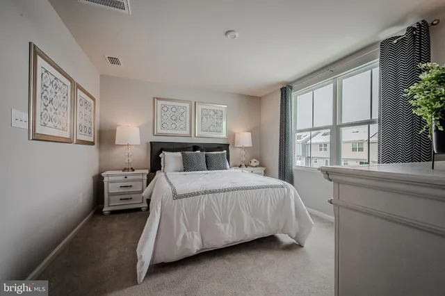 a bedroom with a large bed and a large window