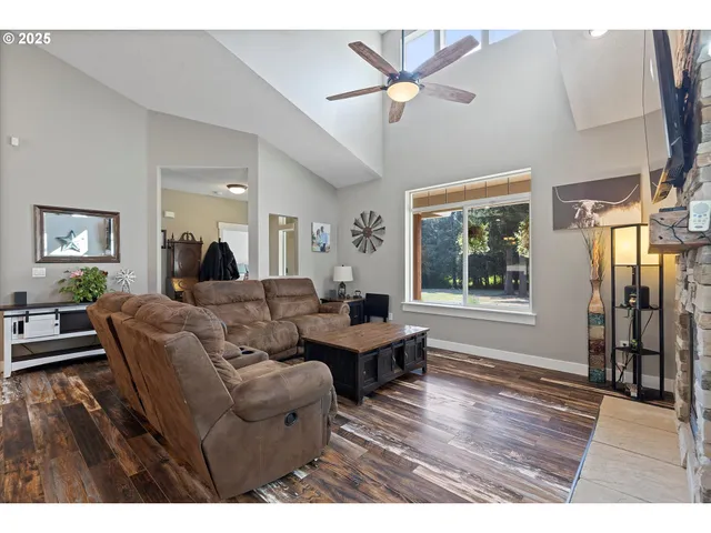 a living room with furniture a fireplace and wooden floor