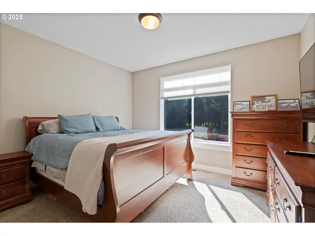 a bedroom with a bed and a dresser