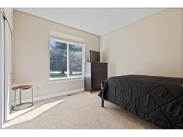 a bedroom with a bed and a chair