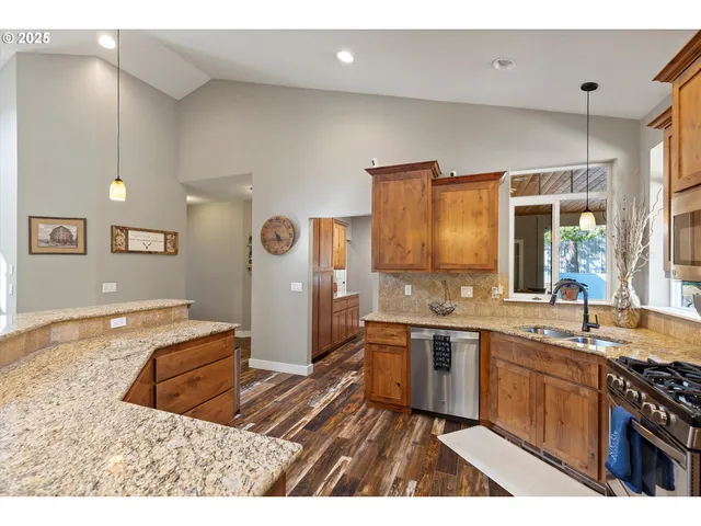 a kitchen with a sink stainless steel appliances and cabinets