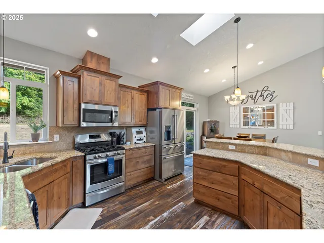 a kitchen with a sink a counter space appliances and cabinets