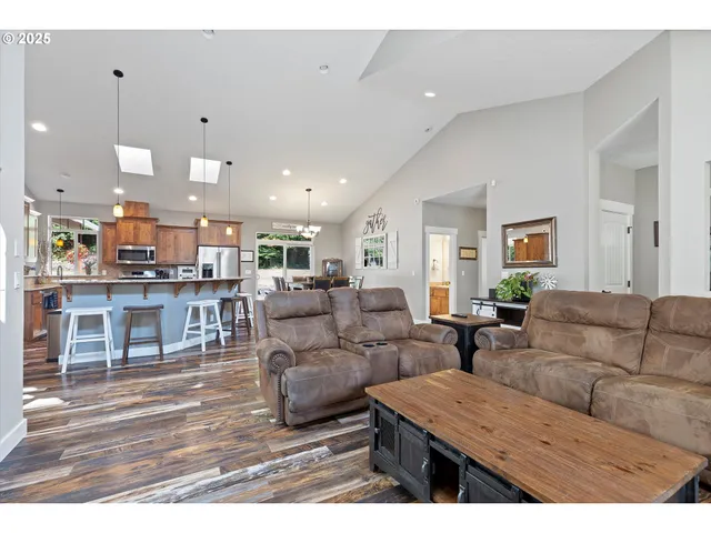 a living room with furniture wooden floor and window