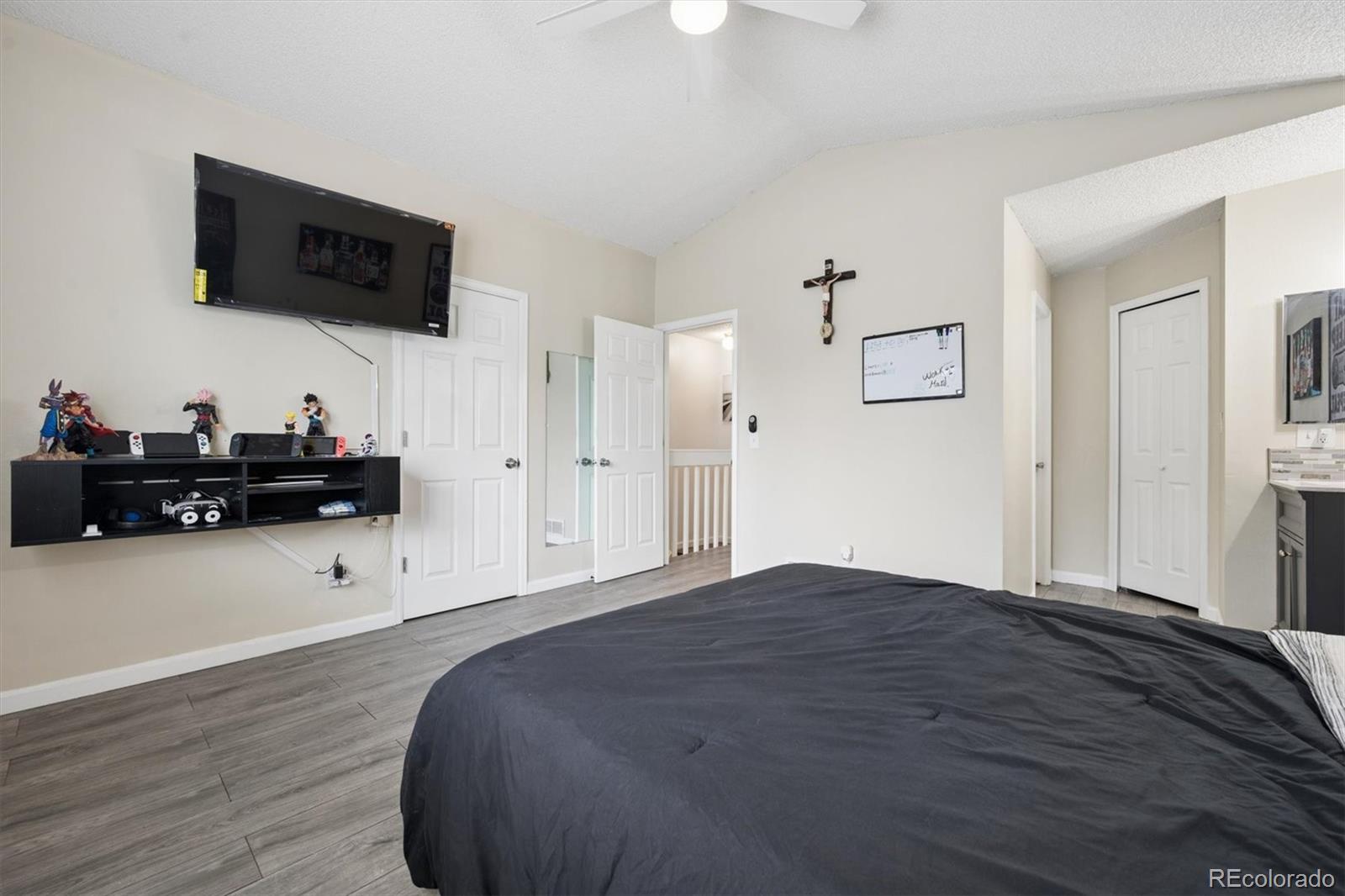 11688 East Cedar Avenue Aurora, CO 80012 - Photo 12 of 24 a bedroom with a bed window and a flat screen tv