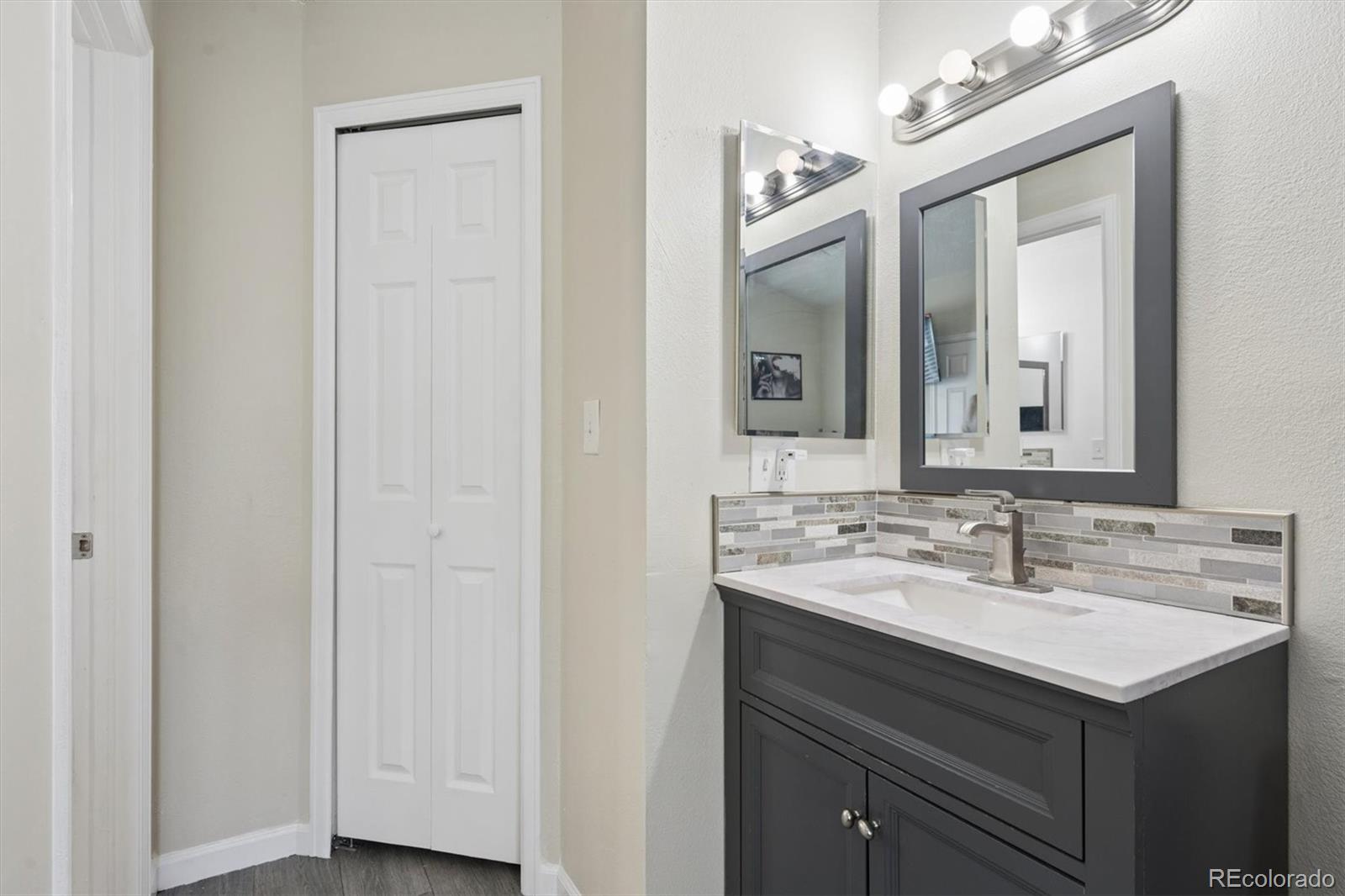 11688 East Cedar Avenue Aurora, CO 80012 - Photo 13 of 24 a bathroom with a sink and a mirror
