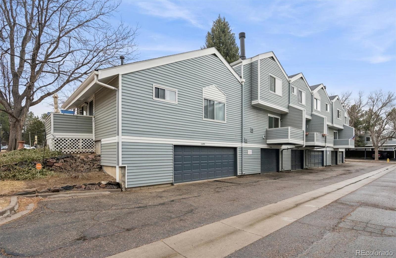 11688 East Cedar Avenue Aurora, CO 80012 - Photo 18 of 24 a front view of a house with a garage